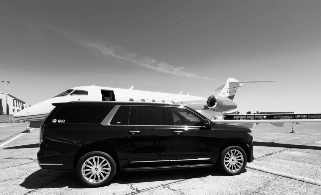 Cadillac Escalade next to private jet