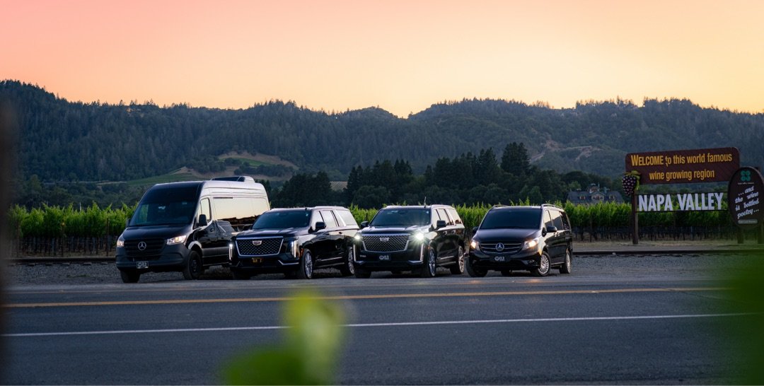 Global Luxury Ride full fleet at Welcome to Napa Valley sign