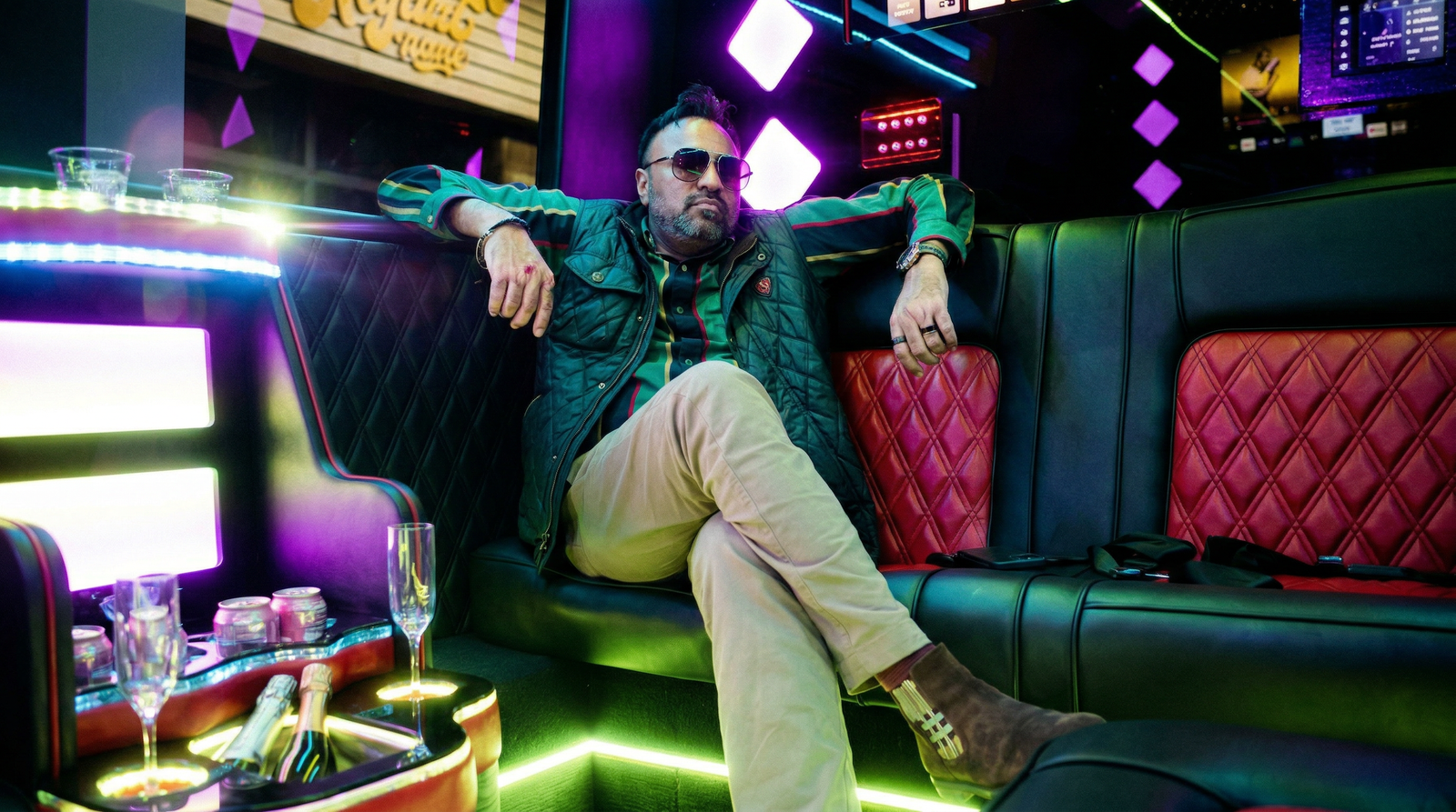 Deep Singh GLR in a luxury party bus with neon lighting